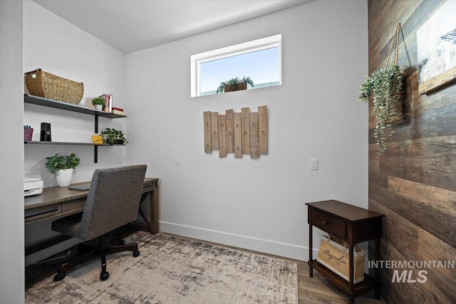 office featuring baseboards and wood finished floors