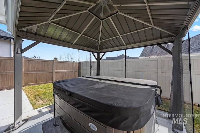 view of parking with a fenced backyard and a gazebo