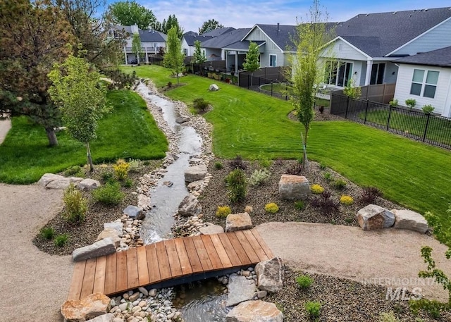 exterior space featuring a yard, fence, and a residential view