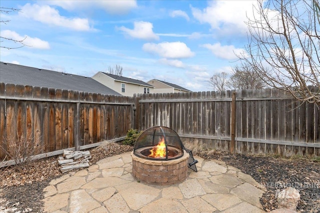 view of patio with a fenced backyard and a fire pit