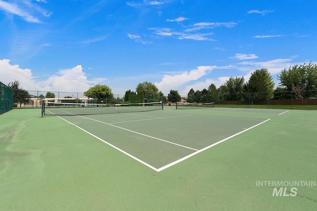 view of tennis court featuring fence