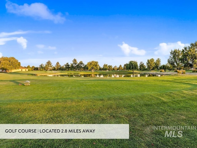 surrounding community featuring a yard and a water view