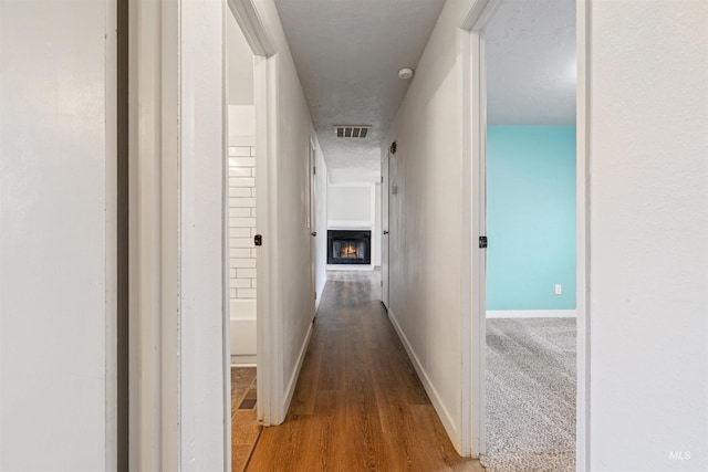 hallway with light hardwood / wood-style flooring