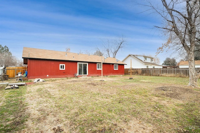 back of property featuring a yard