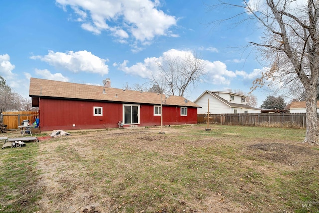 back of property featuring a lawn