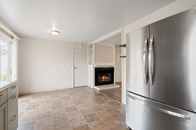 kitchen featuring gray cabinets and stainless steel fridge