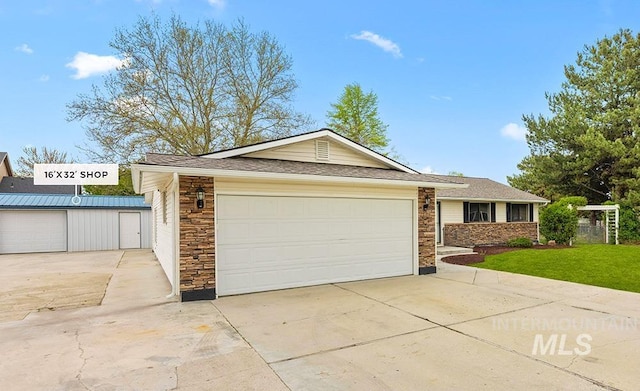 view of front of property featuring driveway, a front lawn, and stone siding
