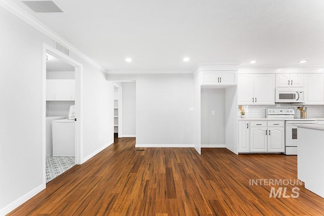 kitchen with light countertops, dark wood finished floors, white cabinets, and white appliances