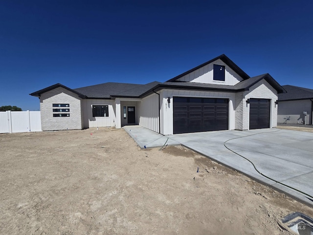 531 Full Moon Way, Twin Falls, ID 83301 - modern farmhouse style home with an attached garage, driveway, and board and batten siding