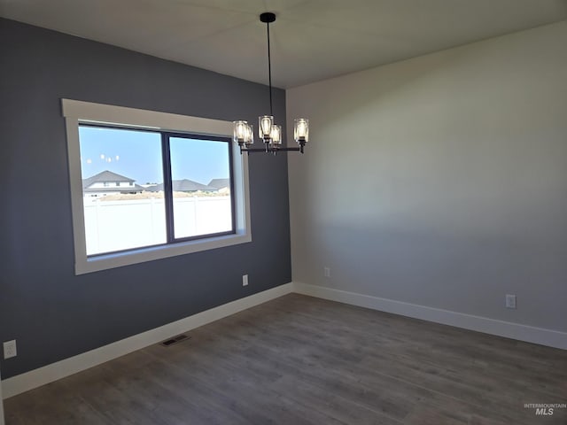 531 Full Moon Way, Twin Falls, ID 83301 - empty room featuring a chandelier and dark wood finished floors