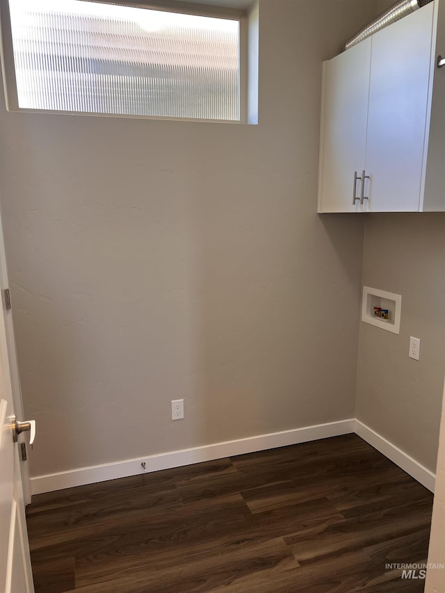 laundry area featuring cabinets, dark hardwood / wood-style floors, and hookup for a washing machine