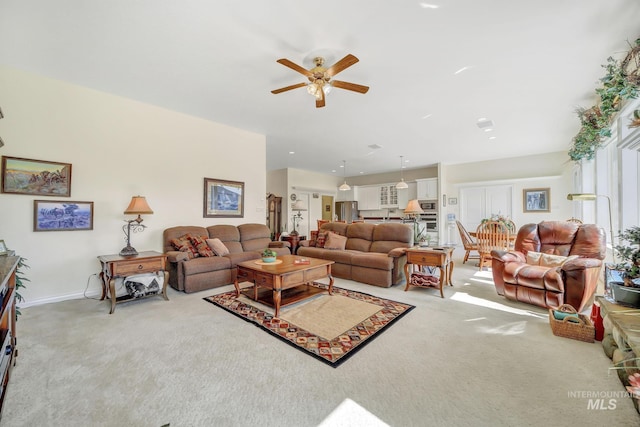 living room featuring light carpet and ceiling fan