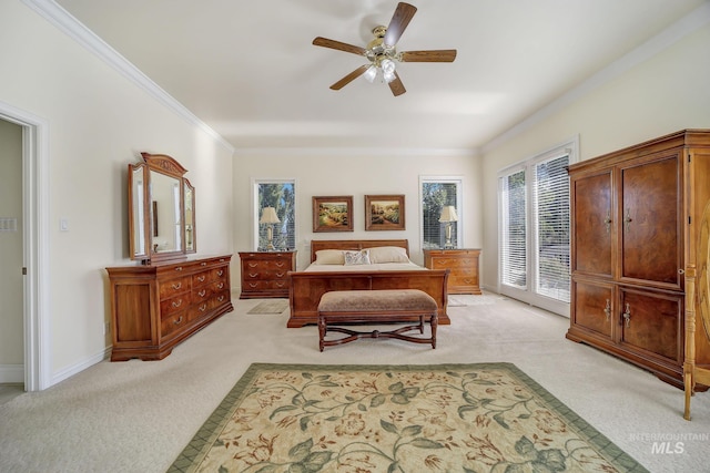 carpeted bedroom with ceiling fan and crown molding