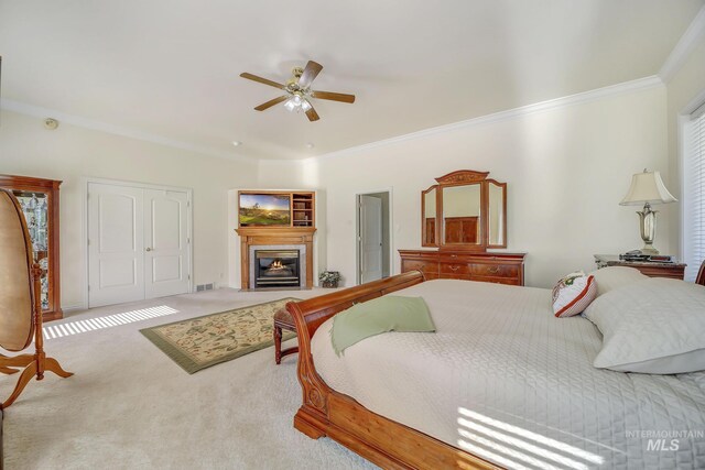 bedroom featuring ceiling fan, a closet, carpet floors, and ornamental molding