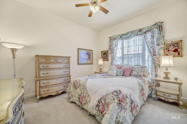 bedroom with light carpet and ceiling fan