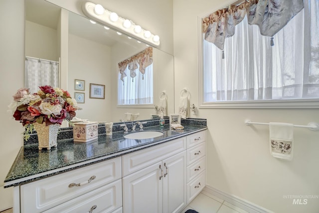 bathroom featuring tile patterned flooring and vanity