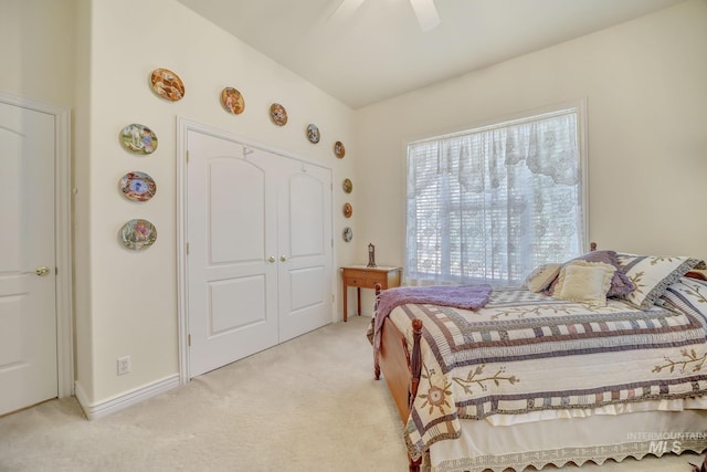 carpeted bedroom featuring ceiling fan and a closet