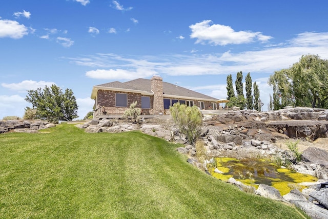 rear view of house with a yard