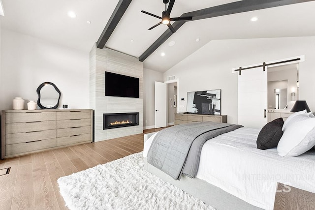 1519 S Galaxy Way, Boise, ID 83712 - bedroom with a barn door, beamed ceiling, light wood-style floors, a fireplace, and high vaulted ceiling