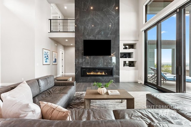 1519 S Galaxy Way, Boise, ID 83712 - living area with a high ceiling, wood finished floors, a premium fireplace, built in shelves, and recessed lighting