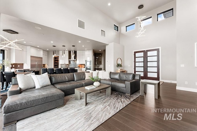1519 S Galaxy Way, Boise, ID 83712 - living area featuring dark wood-style flooring, a chandelier, recessed lighting, a high ceiling, and french doors