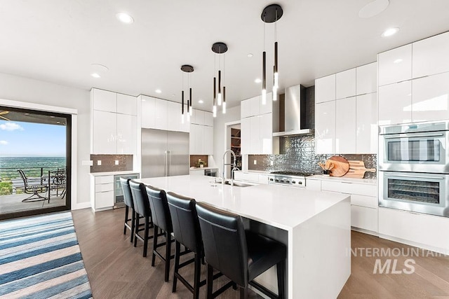 1519 S Galaxy Way, Boise, ID 83712 - kitchen with stainless steel appliances, modern cabinets, wall chimney range hood, beverage cooler, and recessed lighting