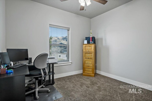 office with dark colored carpet and a textured ceiling