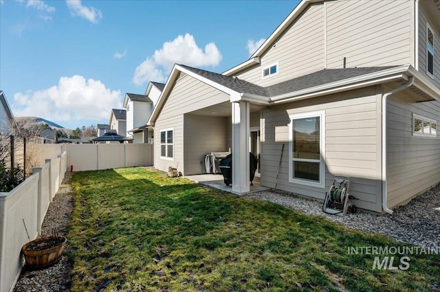 rear view of house featuring a yard