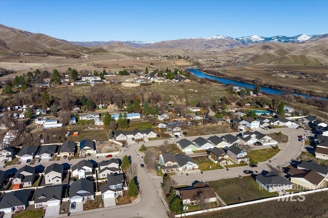 bird's eye view with a water and mountain view