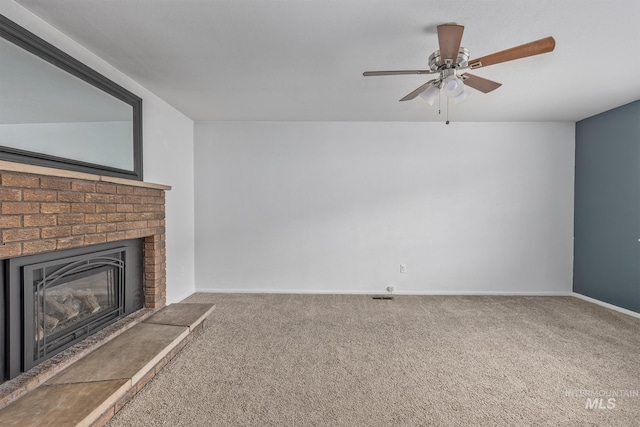 unfurnished living room featuring baseboards, ceiling fan, carpet flooring, and a brick fireplace