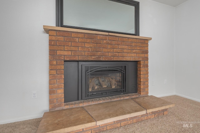 interior details with a fireplace, baseboards, and carpet