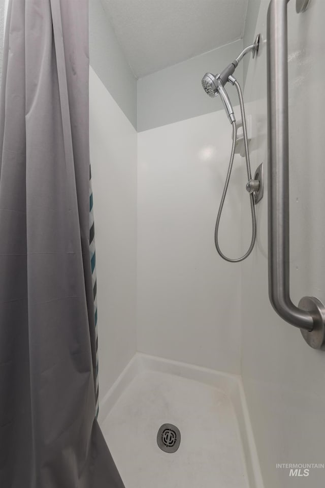 bathroom featuring a shower stall