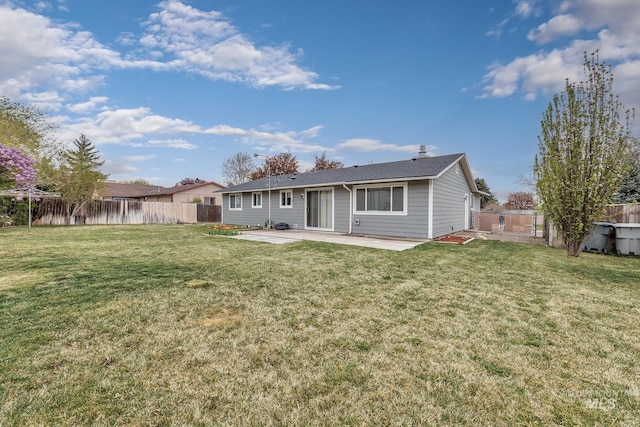 back of house with a patio, a fenced backyard, and a lawn