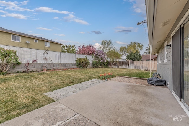 view of yard with a fenced backyard and a patio area