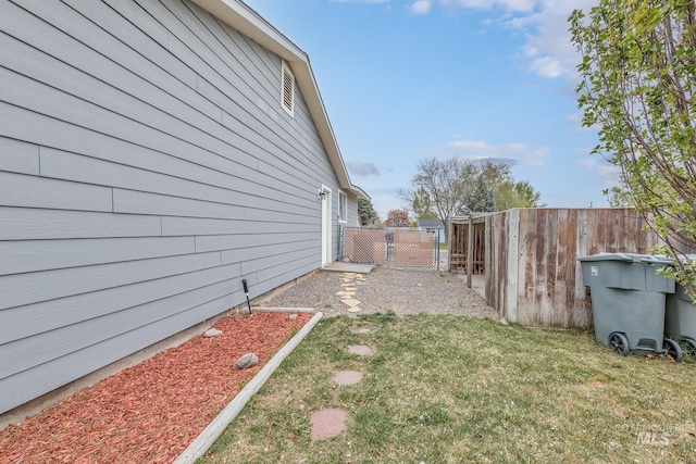 view of yard with fence and a gate