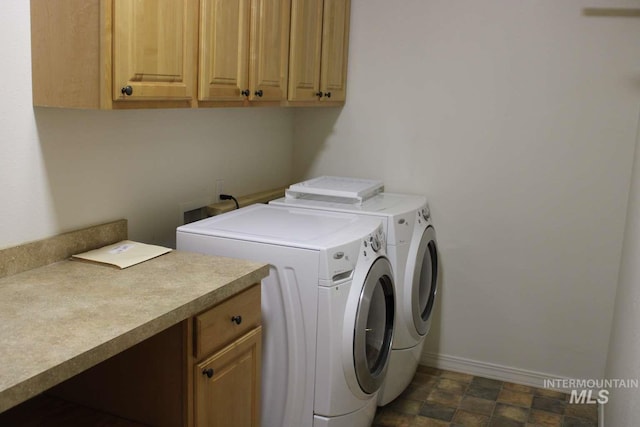 laundry room with independent washer and dryer, cabinet space, and baseboards