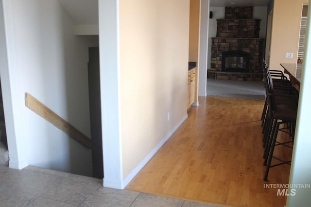 corridor with baseboards and wood finished floors