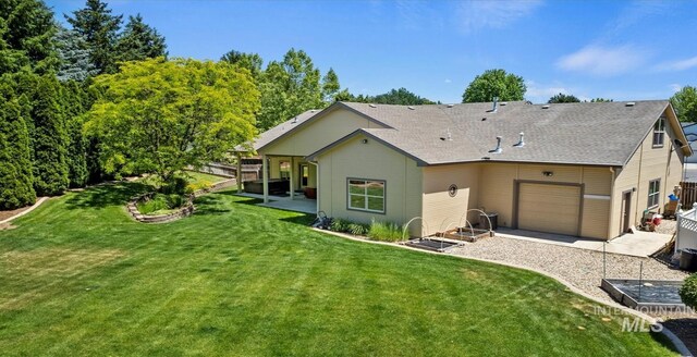 1563 W Colville Ct, Eagle, ID 83616 - rear view of house with an attached garage, gravel driveway, and a shingled roof