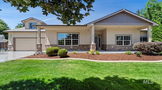 1563 W Colville Ct, Eagle, ID 83616 - craftsman house with a front yard, stone siding, a garage, and driveway