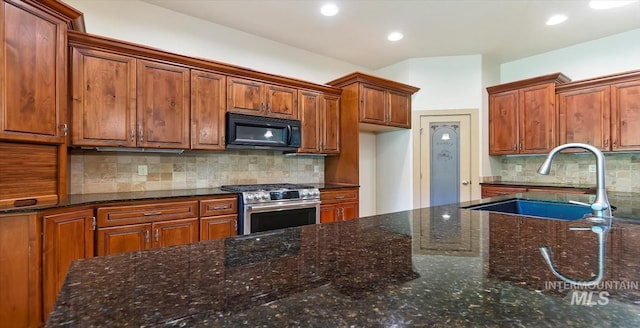 1563 W Colville Ct, Eagle, ID 83616 - kitchen with black microwave, gas stove, tasteful backsplash, brown cabinetry, and recessed lighting
