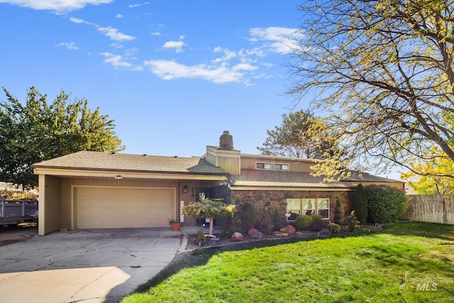 view of front of home with a front yard and a garage