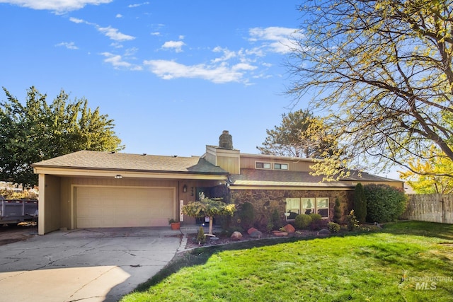 view of front of home with driveway, a chimney, a garage, fence, and a front lawn