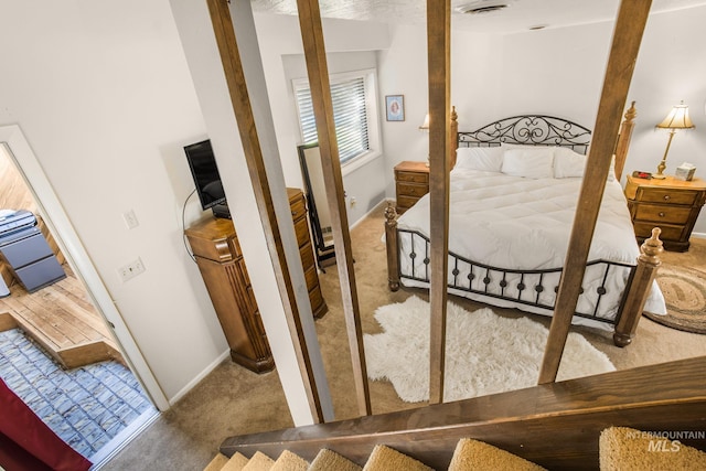 carpeted bedroom with baseboards