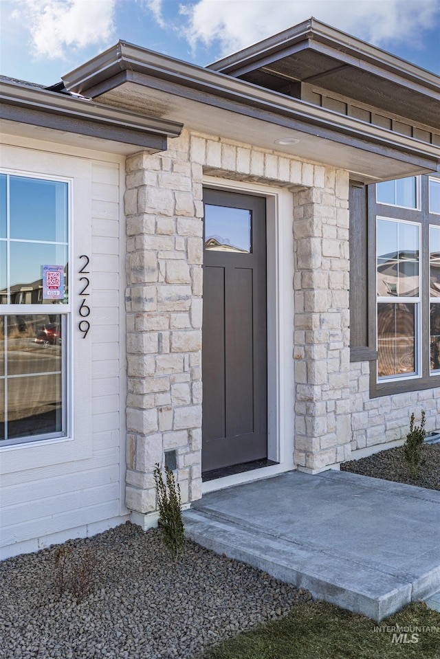 view of exterior entry with stone siding