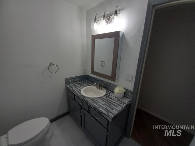 bathroom with vanity and toilet