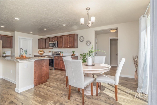 19118 Ralston Way, Caldwell, ID 83605 - dining area with recessed lighting, a textured ceiling, light wood-type flooring, and a chandelier