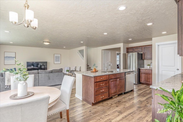 19118 Ralston Way, Caldwell, ID 83605 - kitchen featuring stainless steel appliances, light wood-type flooring, recessed lighting, open floor plan, and a center island with sink
