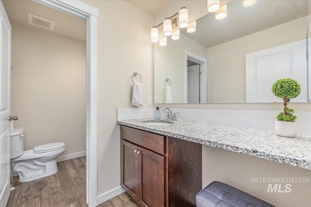 19118 Ralston Way, Caldwell, ID 83605 - bathroom featuring wood finished floors, vanity, and decorative backsplash