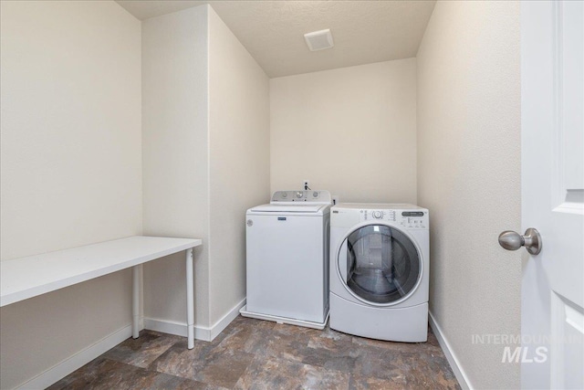 19118 Ralston Way, Caldwell, ID 83605 - laundry room with washing machine and clothes dryer and stone finish floors