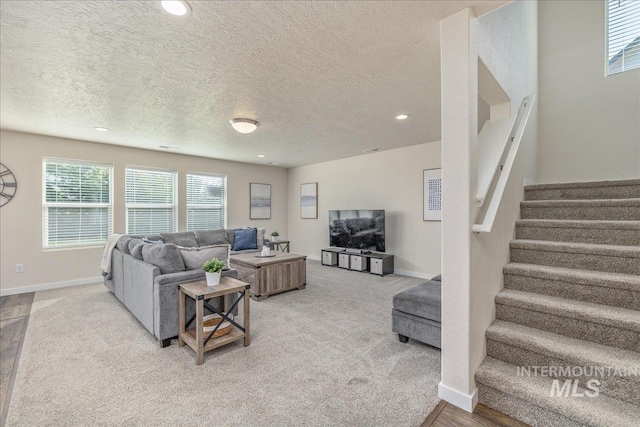 19118 Ralston Way, Caldwell, ID 83605 - living area featuring stairs, a textured ceiling, light carpet, and recessed lighting